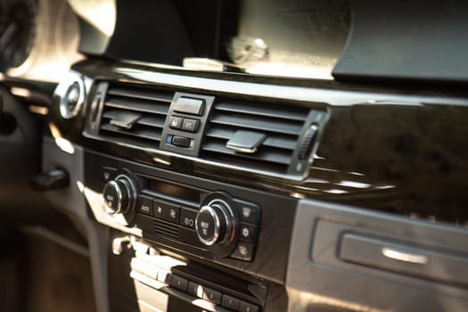 Detailed image of car air vents and ventilation system in a vehicle's interior for comfort.