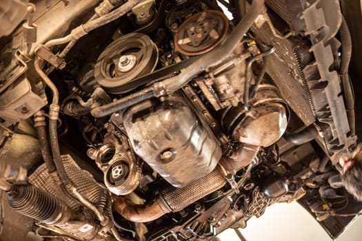 A car engine disassembled in a workshop, highlighting the complexity of automotive repair.