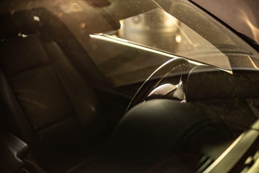 Capturing the subtle reflection on the glass with detailed view of a car's interior, merging aesthetics.