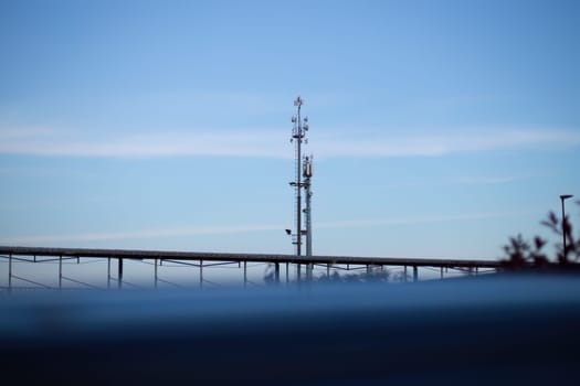 A futuristic cell phone tower rises from the water, its metallic structure gleaming in the sunlight as it provides connectivity to nearby areas.