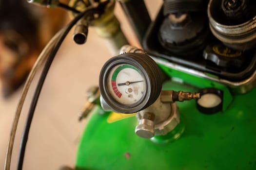 Close-up of an oil suction manometer in a workshop, a tool for vehicle maintenance and repair.