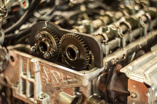 Detailed view of a car engine's timing chain with maintenance and replacement symbol.