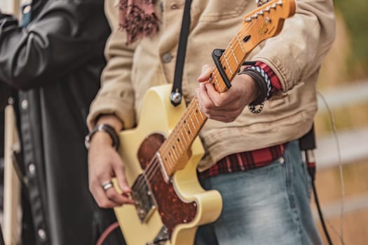 Crowd of individuals standing together, each holding a guitar. They are united in their musical passion and ready to play.