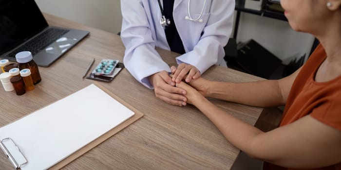 Doctor holding patient hand cheer and encourage while checking your health.