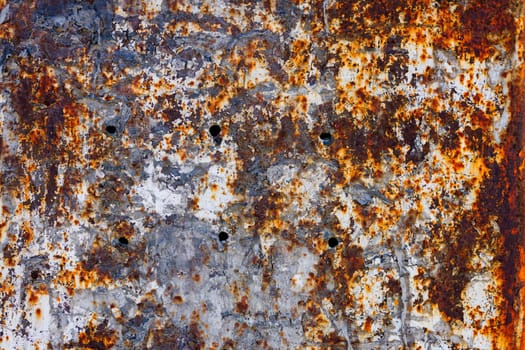 Rusty iron wall with thick layer of eroded and peeled off old paint and scum. Full-frame flat background and texture.