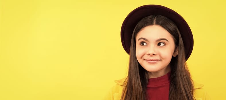 dreamy child with maple leaf on yellow background. autumn. Child face, horizontal poster, teenager girl isolated portrait, banner with copy space