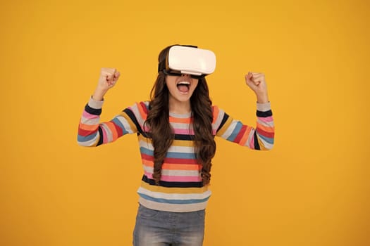 Amazed teenager. Virtual gadgets for child, free time and study. Teen school girl uses vr glasses, isolated on yellow background, studio shot. Excited teen girl