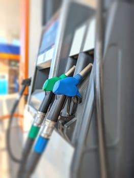 Petrol pump filling fuel nozzle in a gas station. fuel gasoline dispenser background