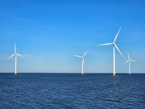 windmill turbines in the ocean generate green energy electrically, and windmills isolated at sea in the Netherlands. Energy transition, zero emissions, carbon neutral, Earth day concept