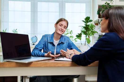 Young teenage girl high school student patient talking with psychologist, therapist, counsellor, social worker. Mental session therapy, support, psychology, psychotherapy, adolescence, youth concept