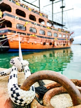Mooring Rope Knot, Close-Up, Holding Moored Ship Near Shore. Symbol of Safety and Stability.