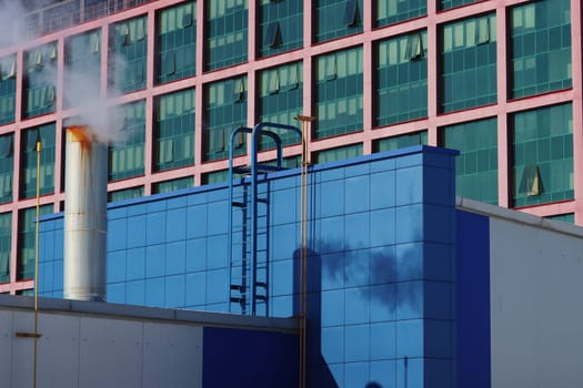 Chimneys of a heating system on the facade of a residential building, Europe.