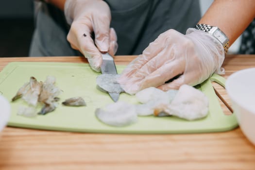 Cooking fish in a cooking mater class. The butchering of the fish. Cooking at home, home-cooked food.