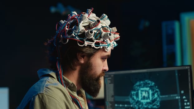IT specialist using EEG headset and deep learning technology to upload brain into computer. Close up of neuroscientific equipment used by man transferring consciousness into cyberspace, camera A