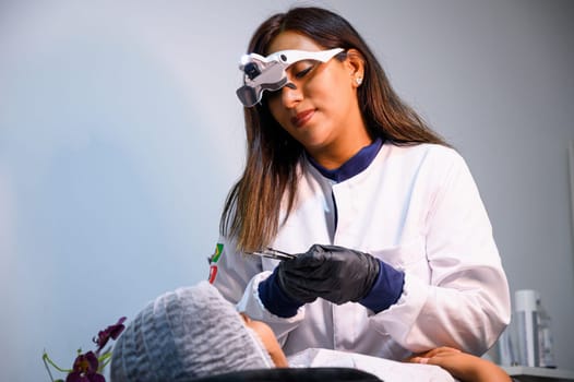 Female dentist examines a patient's teeth in a dental office setting