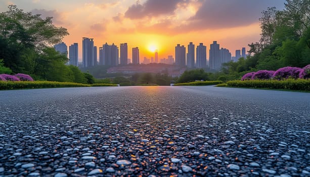 The perspective of the road against the background of sunset and the cityscape. High quality photo