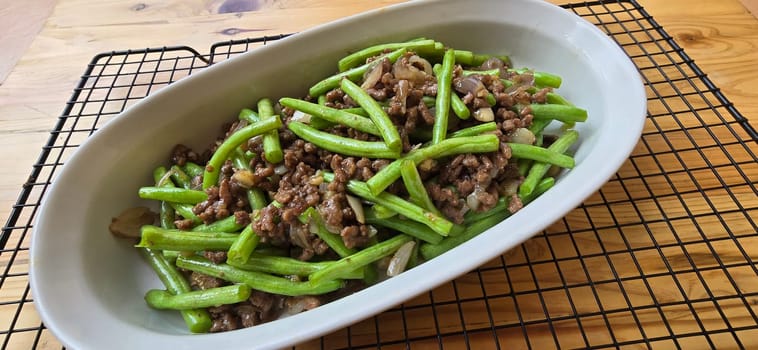 String green bean or french beans with minced beef stir fry or sauteed called Tumis buncis daging sapi cincang in Indonesia, selective focus
