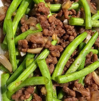 String green bean or french beans with minced beef stir fry or sauteed called Tumis buncis daging sapi cincang in Indonesia, selective focus