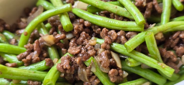 String green bean or french beans with minced beef stir fry or sauteed called Tumis buncis daging sapi cincang in Indonesia, selective focus