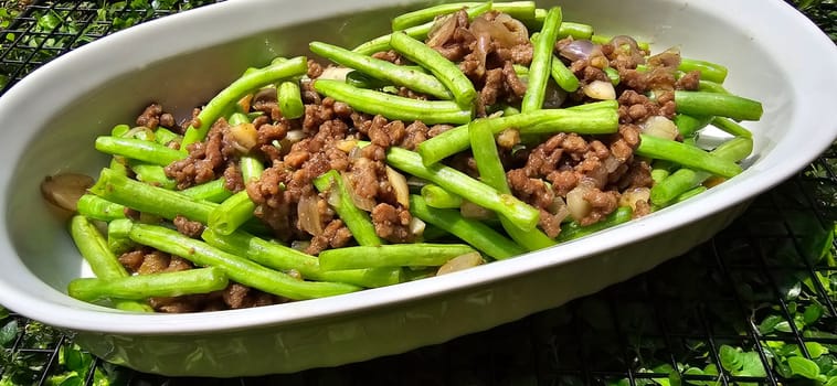 String green bean or french beans with minced beef stir fry or sauteed called Tumis buncis daging sapi cincang in Indonesia, selective focus
