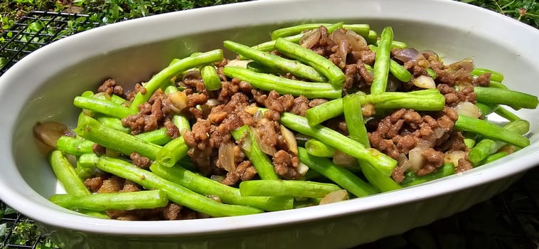 String green bean or french beans with minced beef stir fry or sauteed called Tumis buncis daging sapi cincang in Indonesia, selective focus