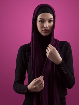 Modern Muslim woman wearing stylish hijab casual wear isolated on pink background. Diverse people model hijab fashion concept. High quality photo