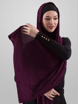 Muslim woman wearing modern stylish wear and hijab isolated on grey background. Diverse people model hijab fashion concept. High quality photo