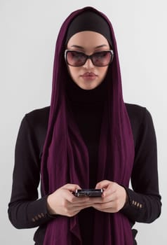 Woman in black stylish fashionable clothes Muslim headscarf. Lady using smart phone, close up portrait of smiling middle eastern girl. High quality photo