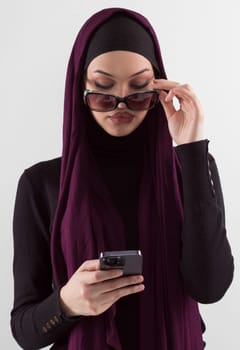 Woman in black stylish fashionable clothes Muslim headscarf. Lady using smart phone, close up portrait of smiling middle eastern girl. High quality photo