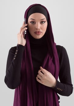 Woman in black stylish fashionable clothes Muslim headscarf. Lady using smart phone, close up portrait of smiling middle eastern girl. High quality photo