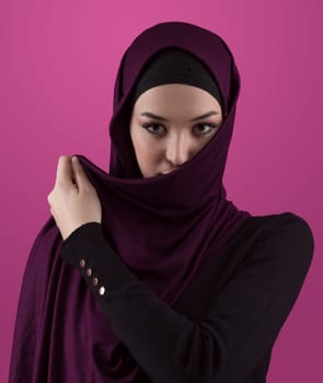 Modern Muslim woman wearing stylish hijab casual wear isolated on pink background. Diverse people model hijab fashion concept. High quality photo