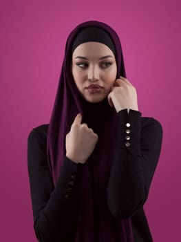 Modern Muslim woman wearing stylish hijab casual wear isolated on pink background. Diverse people model hijab fashion concept. High quality photo