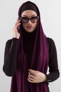 Woman in black stylish fashionable clothes Muslim headscarf. Lady using smart phone, close up portrait of smiling middle eastern girl. High quality photo