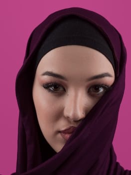 Modern Muslim woman wearing stylish hijab casual wear isolated on pink background. Diverse people model hijab fashion concept. High quality photo