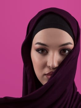 Modern Muslim woman wearing stylish hijab casual wear isolated on pink background. Diverse people model hijab fashion concept. High quality photo