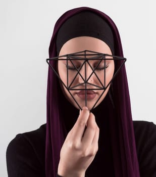 Muslim woman wearing modern stylish wear and hijab isolated on grey background. Diverse people model hijab fashion concept. Face recognition and biometric data identify face science. High quality photo