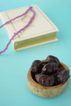 Holy book Quran and rosary on table, close up