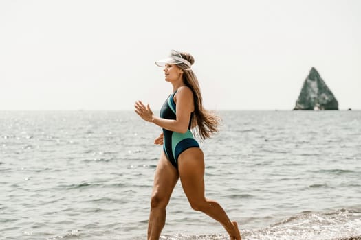 Woman beach vacation photo. A happy tourist in a blue bikini enjoying the scenic view of the sea and volcanic mountains while taking pictures to capture the memories of her travel adventure