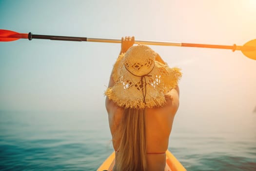 A woman wearing a straw hat is paddling a canoe on a sunny day. Scene is relaxed and carefree, as the woman enjoys her time on the water