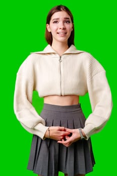 A woman is shown wearing a skirt and a sweater, standing in a casual pose. She appears comfortable and stylish in her outfit choice.