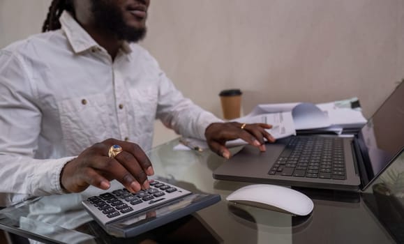 Young African American businessman dressed casually Work from your laptop while you're on vacation by working from home..