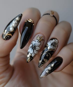 A close up of liquid nail polish on a persons fingers, adorned with flowers and pearls made from natural materials. A beautiful manicure with silver accents and artificial nails