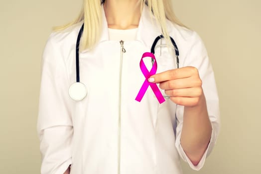 Female Doctor Holds Pink Ribbon, International Breast Cancer Day October 7 - Image