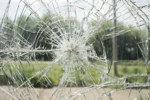 Accident cracked damaged broken shopping mall window glass.