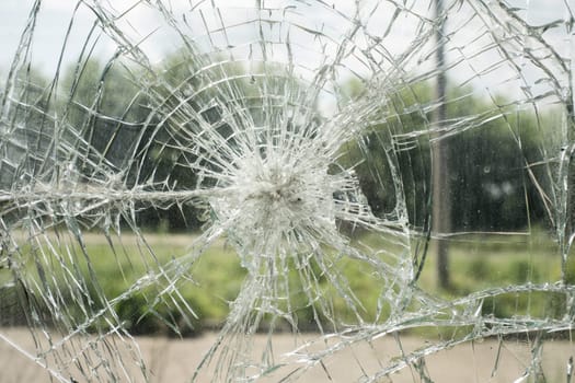 Accident cracked damaged broken shopping mall window glass.