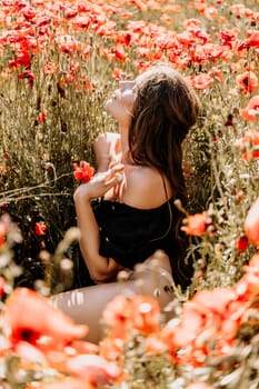 Woman poppies field. portrait of a happy woman with long hair in a poppy field and enjoying the beauty of nature in a warm summer day