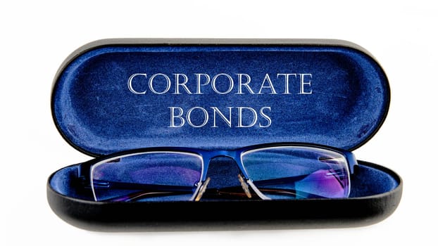 Finance and economics concept. CORPORATE BONDS written on an open case with eyeglasses