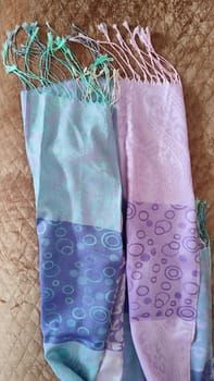 purple blue folded scarf abstraction on fabric, silk, brown bedspread. High quality photo