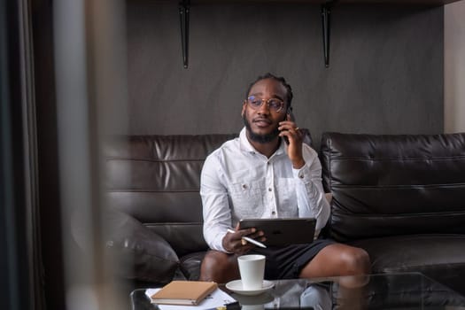 Young African American businessman dressed casually Work from your laptop while you're on vacation by working from home..