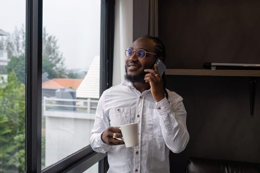 Young African American businessman dressed casually Work from your laptop while you're on vacation by working from home..